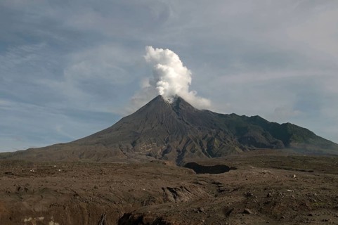 Recently erupted volcano with ash clouds