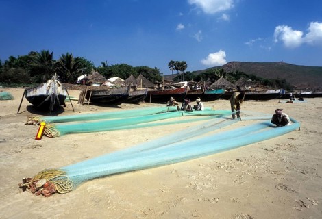 Fishermen repairing their fishing nets in Gangavaram
