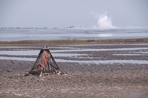 Mosque buried in mud lake of mud volcano