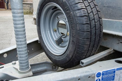 Spare wheel lock on farm trailer in farmyard