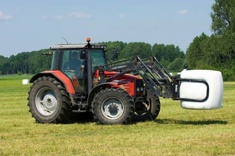 Massey Ferguson 6290 tractor with mechanical loader transporting plastic wrapped silage round bales
