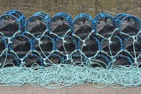 Lobster pots on quayside of harbour
