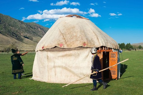Kazakh men building a yurt