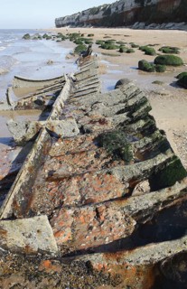 Shipwreck on beach with outgoing tide