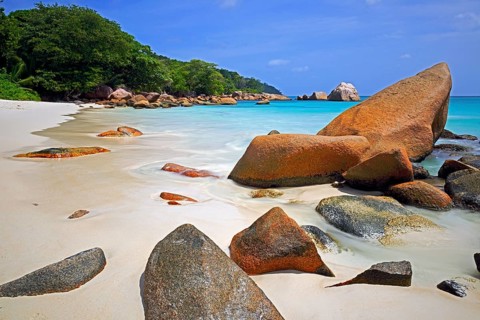 Granite rocks and beach of Anse Lazio in the evening