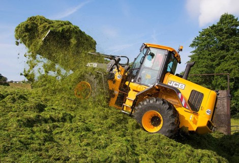 JCB loader compacting grass silage clamp