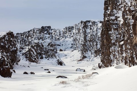 Oexara River flowing through Almannagja Gorge in the snow in winter