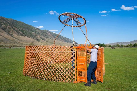 Kazakh men building a yurt