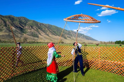 Kazakh men building a yurt