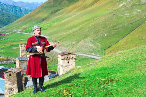 Georgian musician of a folklore group playing panduri