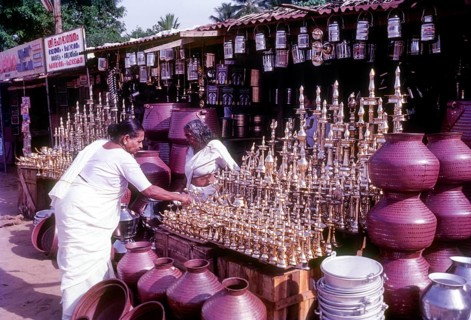 An old women purchasing brass oil lamps in a shop in Ernakulam