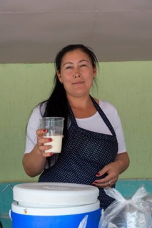Kazakh woman selling kumis made from mare's milk