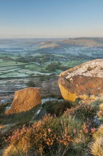 View of cliffs and moorland across the valley at sunrise in frost