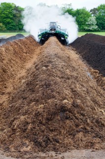 Komptech self-propelled compost turner turning rotting bedding manure