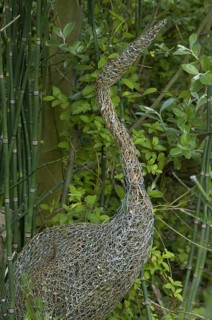 Ornamental wire mesh heron in garden