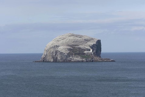 View of volcanic plug island and sea