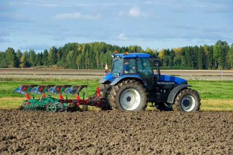New Holland TM150 tractor with reversible plough and harrow
