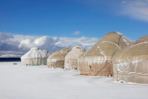 Yurts in a traditional Kyrgyz yurt camp in the snow at Song-Kul Lake