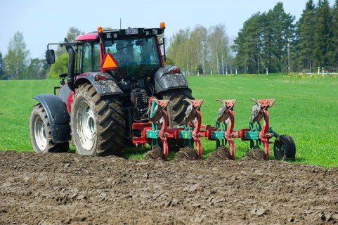 Valtra tractor ploughs field with four-furrow reversible plough