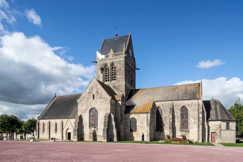 Church of Sainte-Mere-Eglise with parachute memorial in honour of paratrooper John Steele