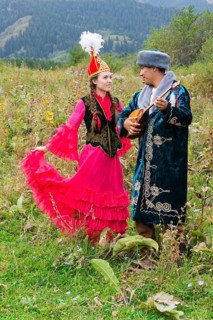 Kazakh man singing and playing dombra for a woman