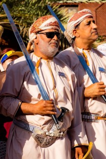 Men performing traditional songs during the Friday Goat Market in Nizwa