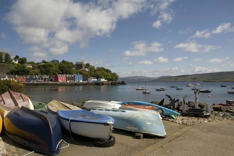 View of boats and anchors on waterfront of coastal town