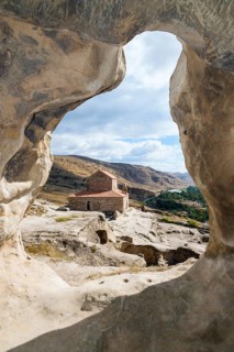 Christian princely basilica from the 10th century with view through a rock arch