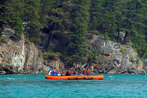 Tourists in a rubber dinghy rafting on the Bow River near Banff