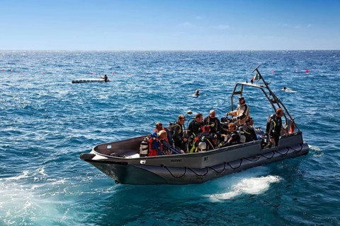 Divers sitting in aluminuim boat