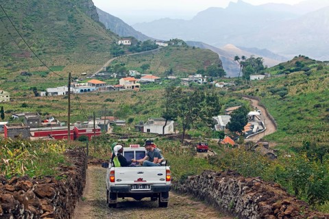 Tourists and locals transported in the back of the pickup truck in the rural landscape on Sao Nicolau Island