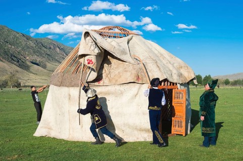 Kazakh men building a yurt