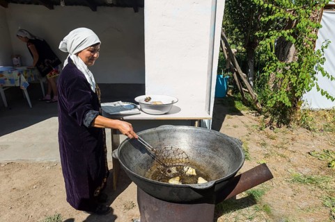 Kazakh woman preparing traditional local tandyr bread