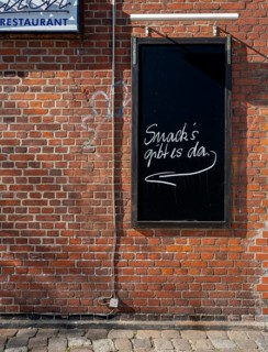 Slate plaque on the brick wall of a restaurant