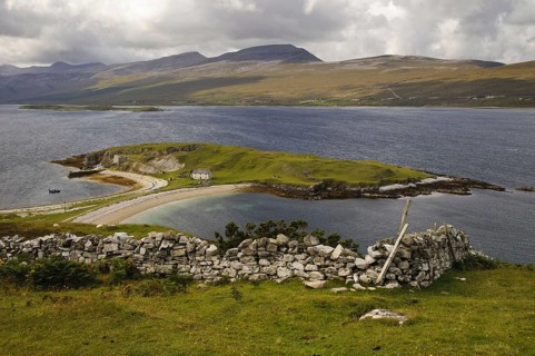 View of land in sea loch connected to mainland by tombolo promontory