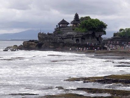 View from tourists in the temple on a rock formation on the coast