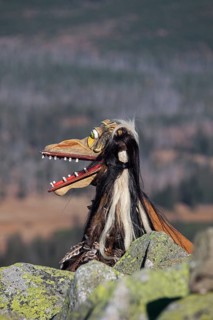 Creepy wooden devil figure on the summit of the Lusen in autumn
