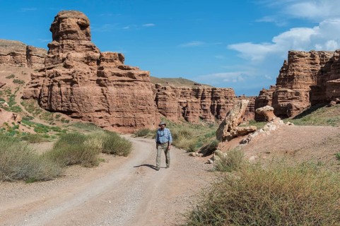 Man walking on the road in Sharyn Canyon National Park and Valley of Castles