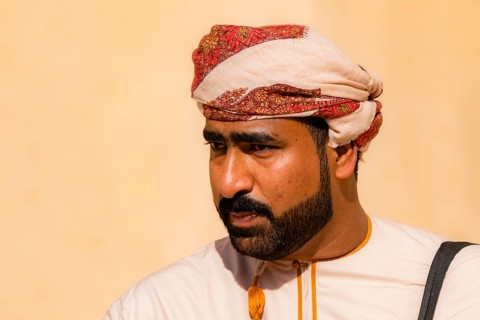 Man performing traditional songs during the Friday Goat Market in Nizwa