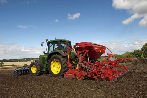 John Deere tractor with front press and rear seed drill