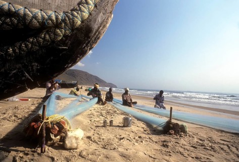Fishermen repairing their fishing nets in Gangavaram