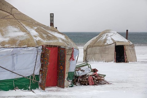 Yurts in the traditional Kyrgyz yurt camp during a snowstorm at Song-Kul Lake