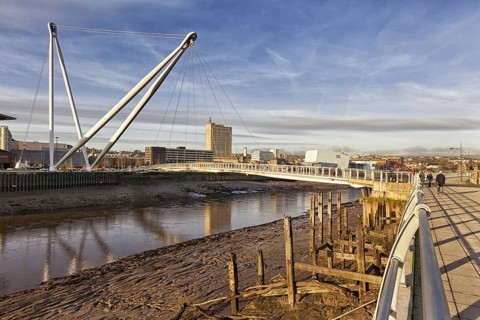 View of tidal river and footbridge