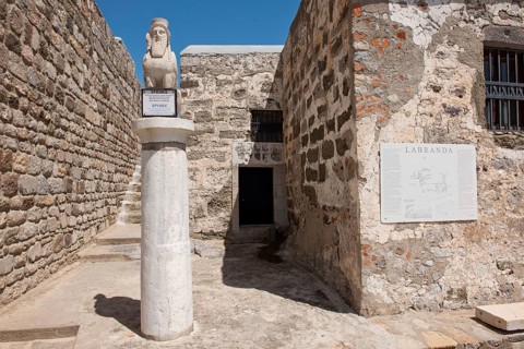 Sphinx with beard and wings on pillar