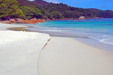 Beach and rocks of Anse Lazio in the evening