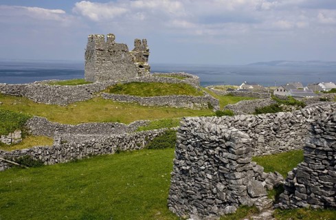 Ruins of a medieval castle between dry stone walls