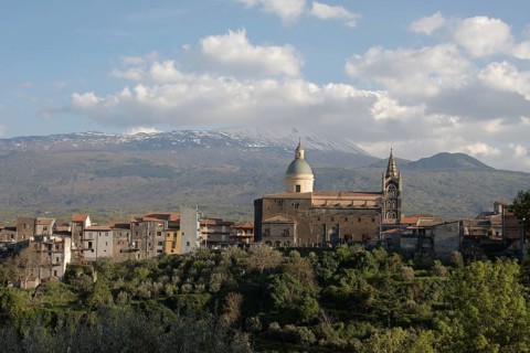 View of a village with volcano in the background
