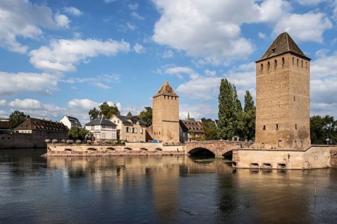 Towers of the medieval bridge Ponts Couverts over the river Ill in the Petite France district of the city of Strasbourg
