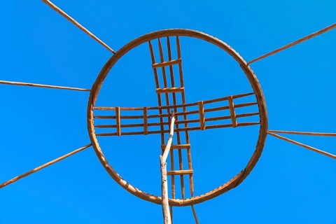 Kazakh men erecting the roof of a yurt