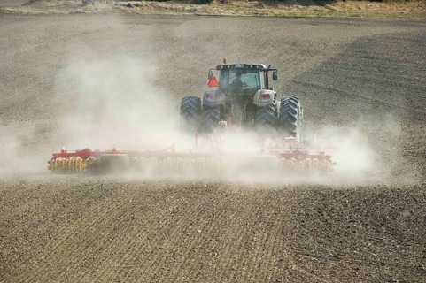 Valtra tractor with Vaderstad NZA-800 and Vaderstad RS-820 harrows and rollers working dusty farmland